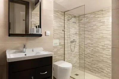 a bathroom with a toilet and a sink and a shower at To Rodi Apartments in Rhodes Town