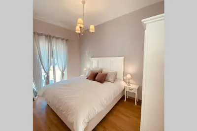 a bedroom with a white bed and a window at Casa del Sud in Apolakkiá