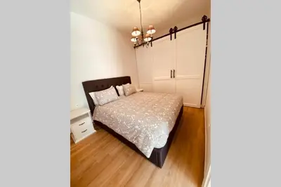a bedroom with a bed and white cabinets at Casa del Sud in Apolakkiá