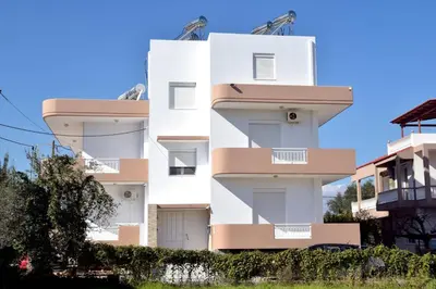 a white building with balconies on the side of it at ANTONIOS apartments in Archangelos