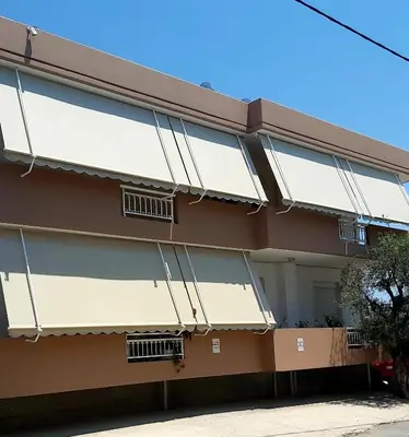 a building with white and brown at ANTONIOS apartments in Archangelos