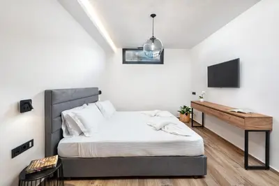 a bedroom with a bed and a desk at Aurum Villas in Ialyssos