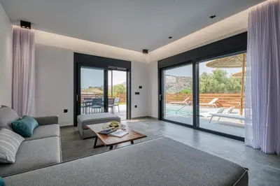 a living room with a couch and a table at Terra Secreta Luxury Villas in Lardos