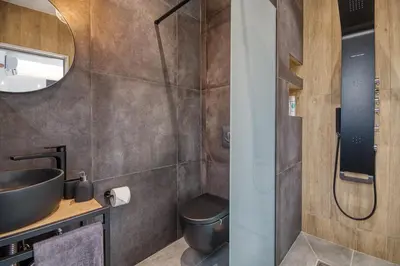 a bathroom with a sink and a toilet and a shower at Terra Secreta Luxury Villas in Lardos