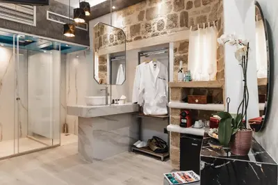 a bathroom with a sink and a shower at Chateau Anax Luxury suites in Rhodes Town