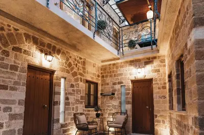 a stone hallway with chairs and a balcony at Chateau Anax Luxury suites in Rhodes Town