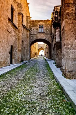 an alley way in an old building with an archway at Chateau Anax Luxury suites in Rhodes Town