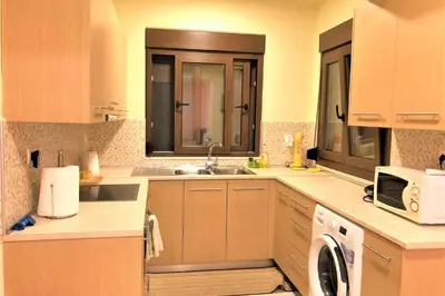 a kitchen with a sink and a microwave at Fiore di Rodi - Private Pool, Jacuzzi and Barbecue in Ialyssos