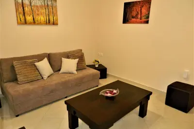 a living room with a couch and a coffee table at Fiore di Rodi - Private Pool, Jacuzzi and Barbecue in Ialyssos