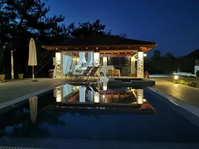 a villa with a swimming pool at night at Fiore di Rodi - Private Pool, Jacuzzi and Barbecue in Ialyssos