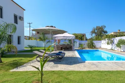 a villa with a swimming pool and a house at Villa Costa in Ixia