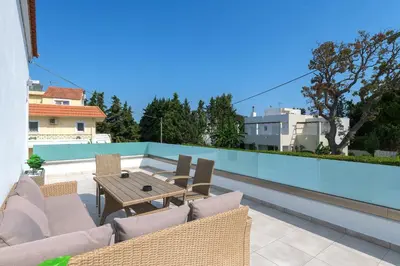 a patio with a table and chairs on a roof at Villa Costa in Ixia