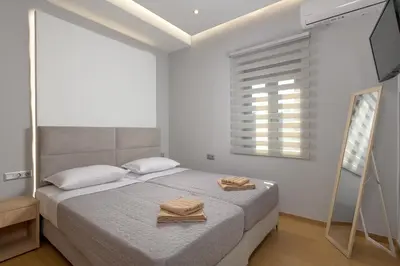 a bedroom with a bed with two towels on it at Villa Costa in Ixia
