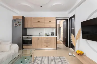a living room with a couch and a kitchen at White House Kokas Luxury Apartments in Kremasti