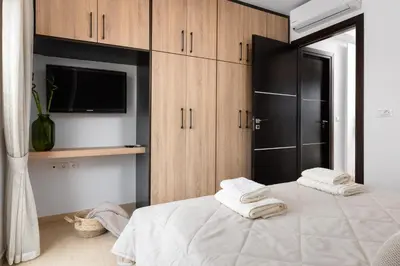 a bedroom with a bed with towels on it at White House Kokas Luxury Apartments in Kremasti