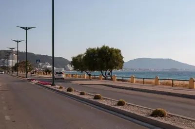 an empty street next to a body of water at Maria's Little apartment in Rhodes Town