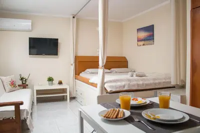 a bedroom with a bed and a table with food on it at Maria's Little apartment in Rhodes Town