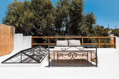 a table with two chairs on top of a patio at CasaCarma I, privater Pool, Boho-Design, Tradition in Lachania