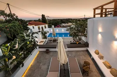 a patio with a table and chairs and a pool at CasaCarma I, privater Pool, Boho-Design, Tradition in Lachania