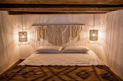 a bedroom with a bed with two lights on it at CasaCarma I, privater Pool, Boho-Design, Tradition in Lachania