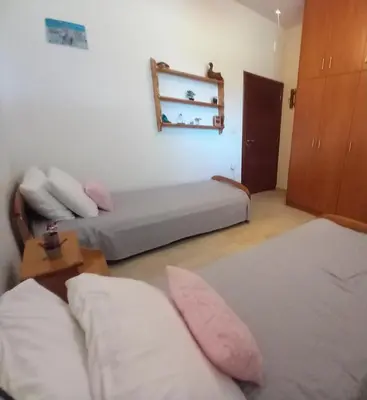 two beds in a room with pink pillows at Family room Rhodes Greece in Ialyssos