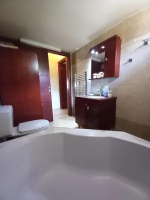 a bathroom with a tub and a toilet and a sink at Family room Rhodes Greece in Ialyssos