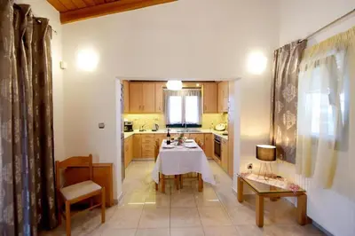 a kitchen with a table and chairs in a room at Kiparisia Villa in Phanaes
