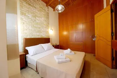 a bedroom with a bed with two towels on it at Kiparisia Villa in Phanaes