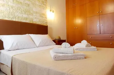 a bedroom with two towels on a bed at Kiparisia Villa in Phanaes