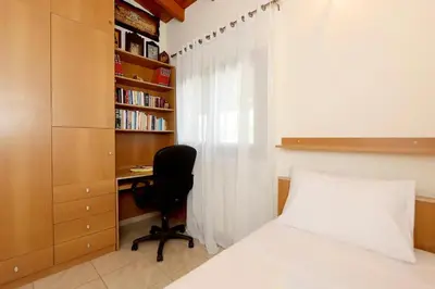 a bedroom with a desk and a bed and a chair at Kiparisia Villa in Phanaes