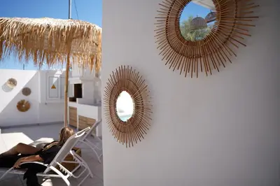 a woman sitting in a chair in front of a mirror at Villa Pastida - Private Pool & Jacuzzi & Central place in Pastida