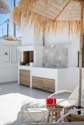 a kitchen with white cabinets and a table and chairs at Villa Pastida - Private Pool & Jacuzzi & Central place in Pastida