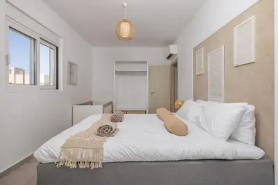 a bedroom with a large white bed with towels on it at Villa Pastida - Private Pool & Jacuzzi & Central place in Pastida