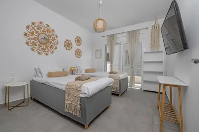 a bedroom with two beds and a tv in it at Villa Pastida - Private Pool & Jacuzzi & Central place in Pastida