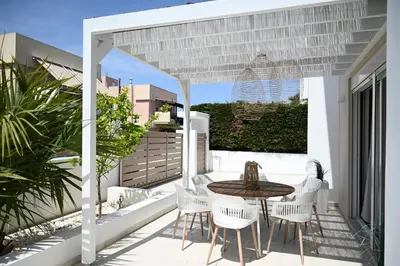 a patio with a table and chairs on a balcony at Villa Pastida - Private Pool & Jacuzzi & Central place in Pastida