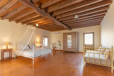 a large room with two beds and a wooden ceiling at Bonseye 2Floor, sea, nature & relax in Kalavárda