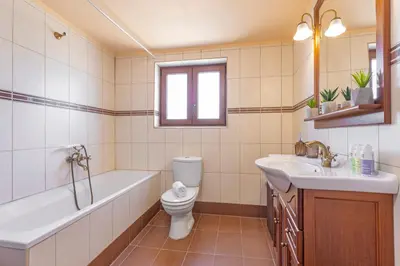 a bathroom with a tub and a toilet and a sink at Bonseye 2Floor, sea, nature & relax in Kalavárda
