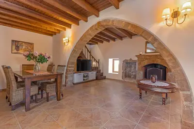 a living room with a table and a fireplace at Bonseye 2Floor, sea, nature & relax in Kalavárda