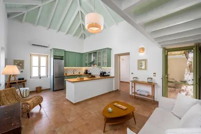 a kitchen and living room with a couch and a table at Villa Theoni in Halki