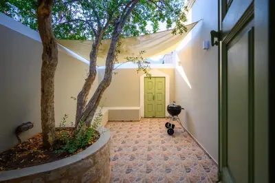 a hallway with a tree in front of a door at Villa Theoni in Halki