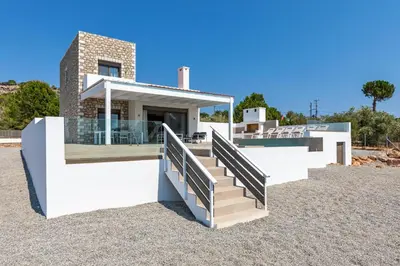a house with a staircase in front of it at Villa AmberBlue Pefkos in Pefki Rhodes
