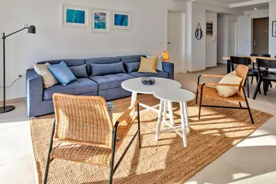 a living room with a couch and a table and chairs at Villa AmberBlue Pefkos in Pefki Rhodes