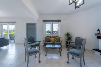 a living room with chairs and a couch at Villa Giota Luxury Living with Private Jacuzzi and Free Car in Theologos