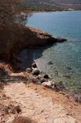 a large body of water next to a rocky shore at Antoniadi Rooms in Livadia