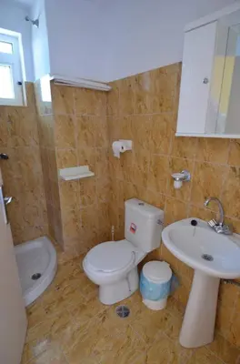 a bathroom with a toilet and a sink at Marianthi Studios Stegna in Archangelos