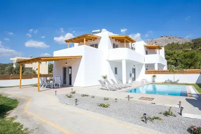 a villa with a swimming pool and a house at Rhodian Dunes Villas with Private Pool in Kiotari
