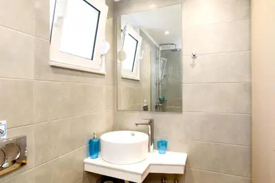 a bathroom with a sink and a mirror at Rhodian Dunes Villas with Private Pool in Kiotari