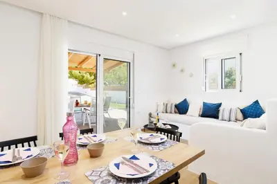 a living room with a table and a couch at Rhodian Dunes Villas with Private Pool in Kiotari