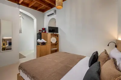a bedroom with a large bed in a room at Voyaz Boutique Apartments & Suites -Old Town in Rhodes Town