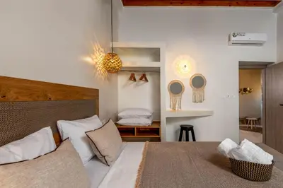 a bedroom with a large bed with white pillows at Voyaz Boutique Apartments & Suites -Old Town in Rhodes Town